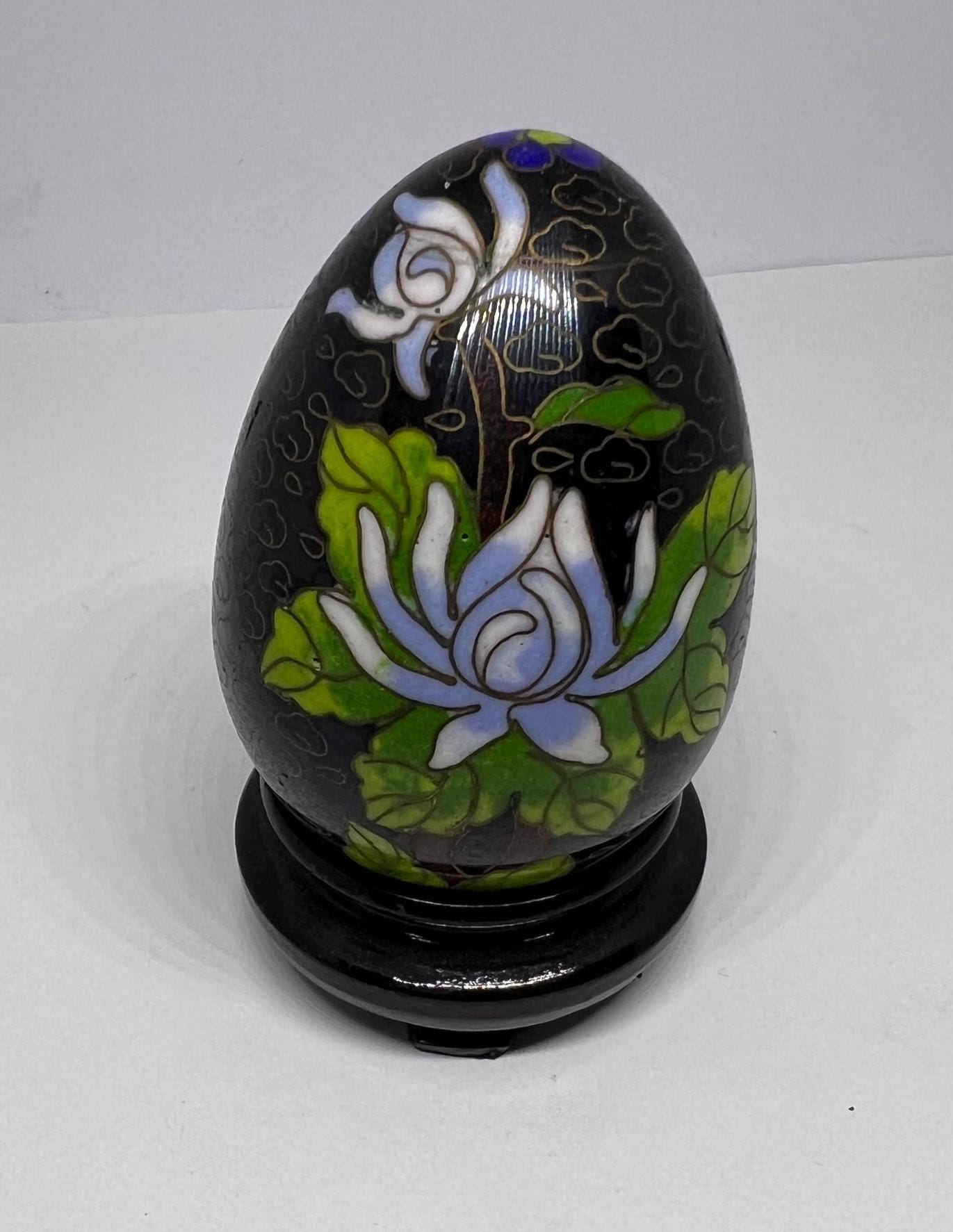Vintage cloisonne egg with stand. Stunning floral design on black enamel background.
