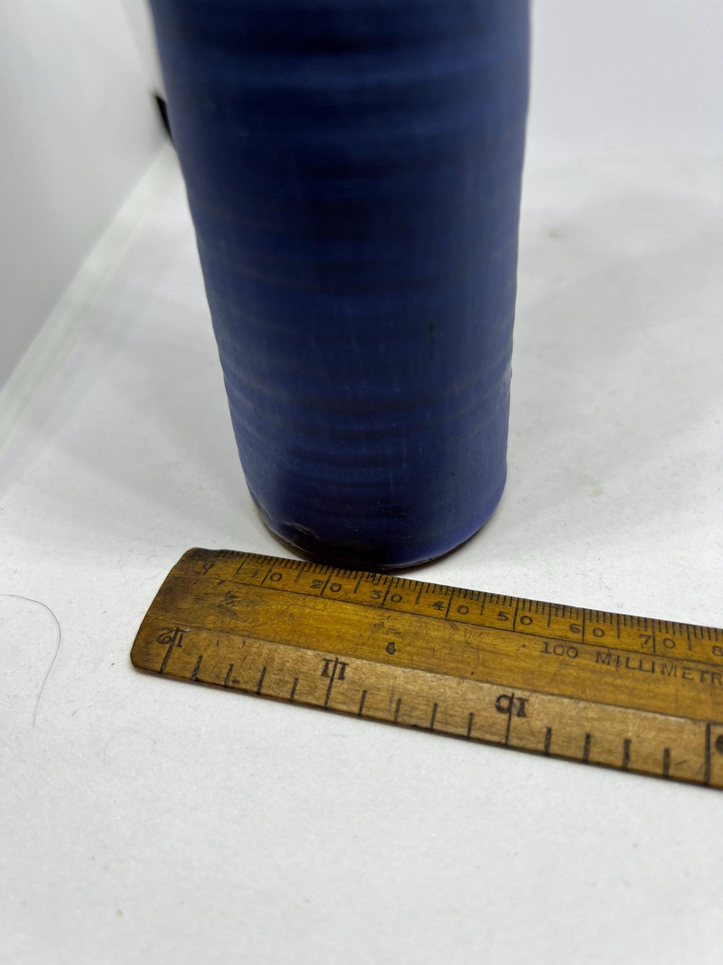 Quirky studio pottery bud vase with blue white glaze.