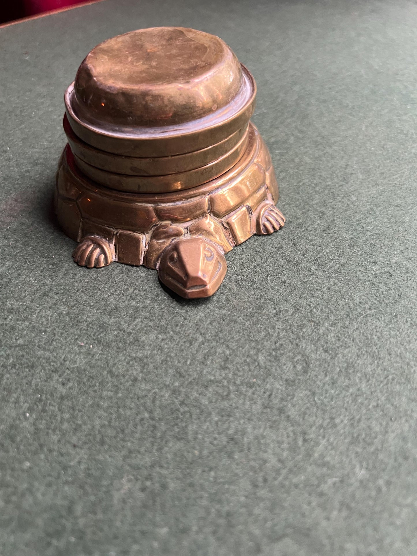 Quirky enamel brass stacking ashtrays on tortoise base.