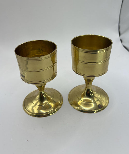Pair of vintage brass footed candle holders. Decorative goblet shaped candlestick holders.