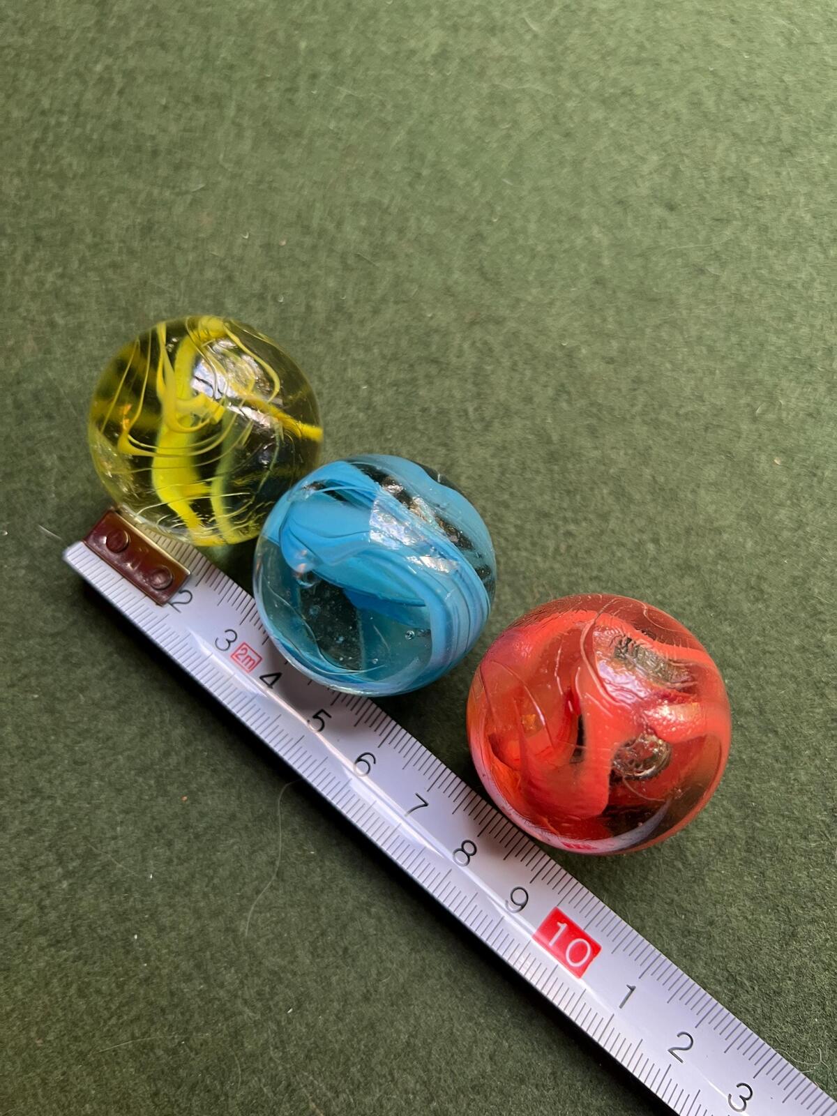 Set 3 vintage dobber marbles. Red Yellow blue spaghetti swirl.