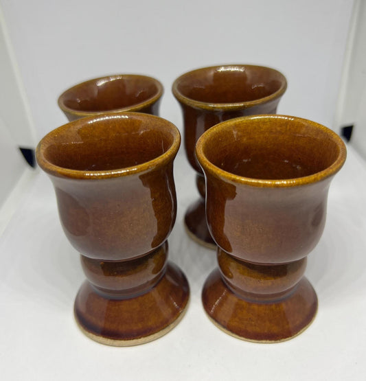 Set of four egg cups Brown glaze footed ceramic egg cup collection 1970s style.