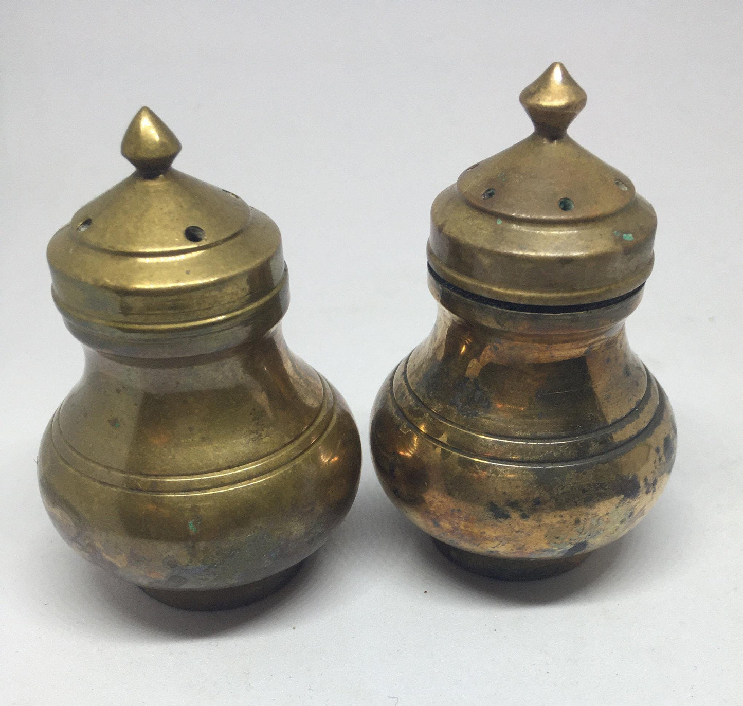 Unusual brass salt and pepper shakers. Screw off lids plastic inserts. Some oxidation.