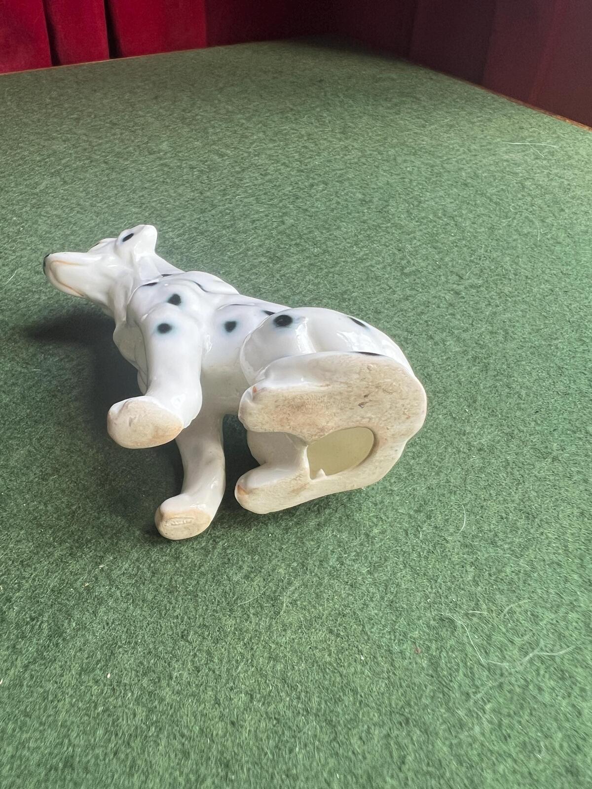 Vintage ceramic dalmatian dog figurine. Porcelain black and white spotty dog.