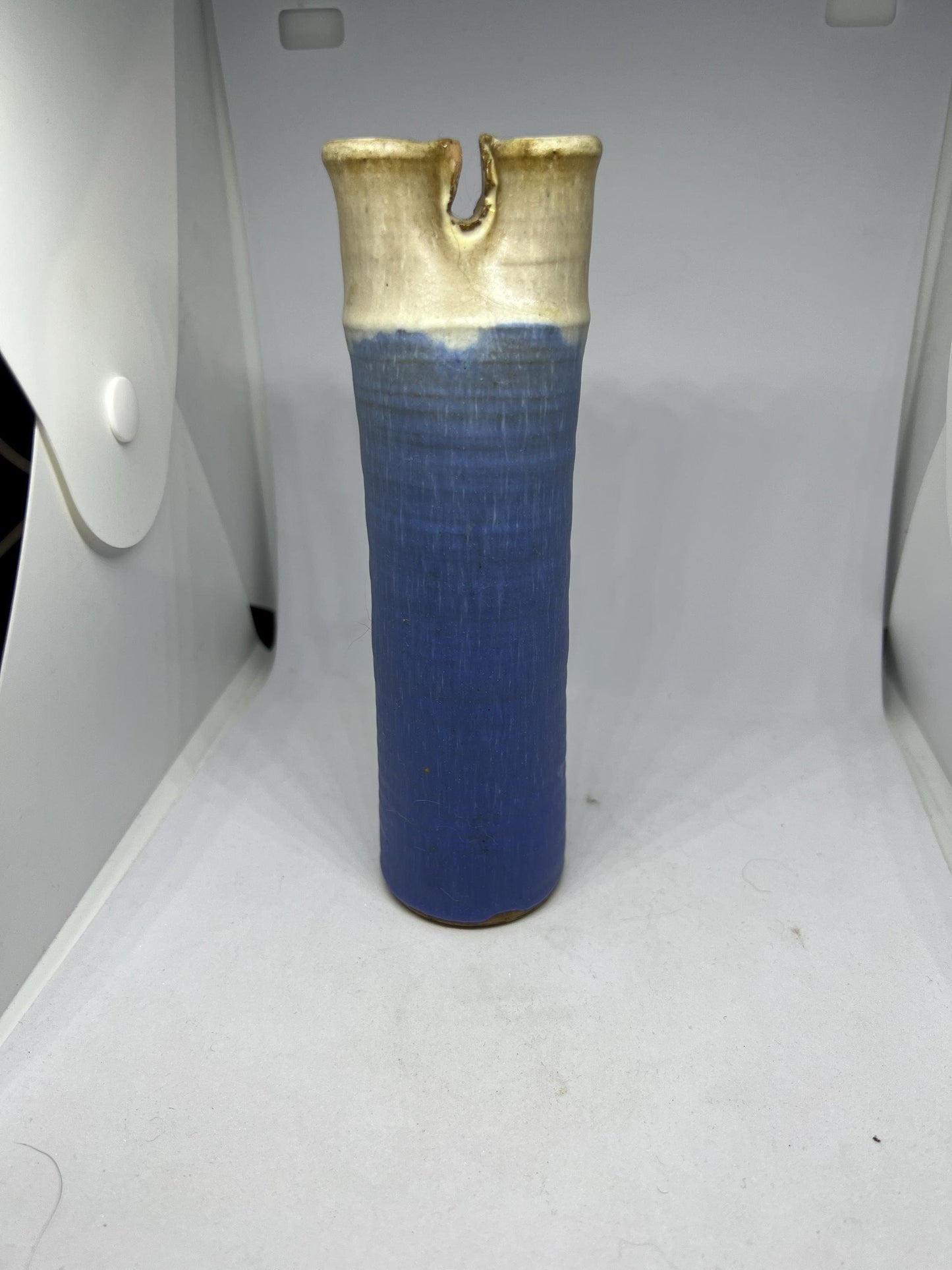 Quirky studio pottery bud vase with blue white glaze.