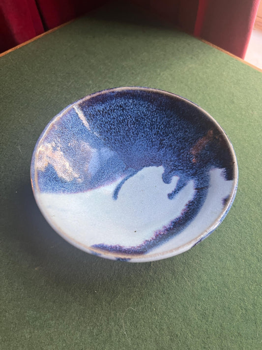 Studio pottery bowl. Hand thrown stone ware with blue white drip glaze. Signed footed bowl.