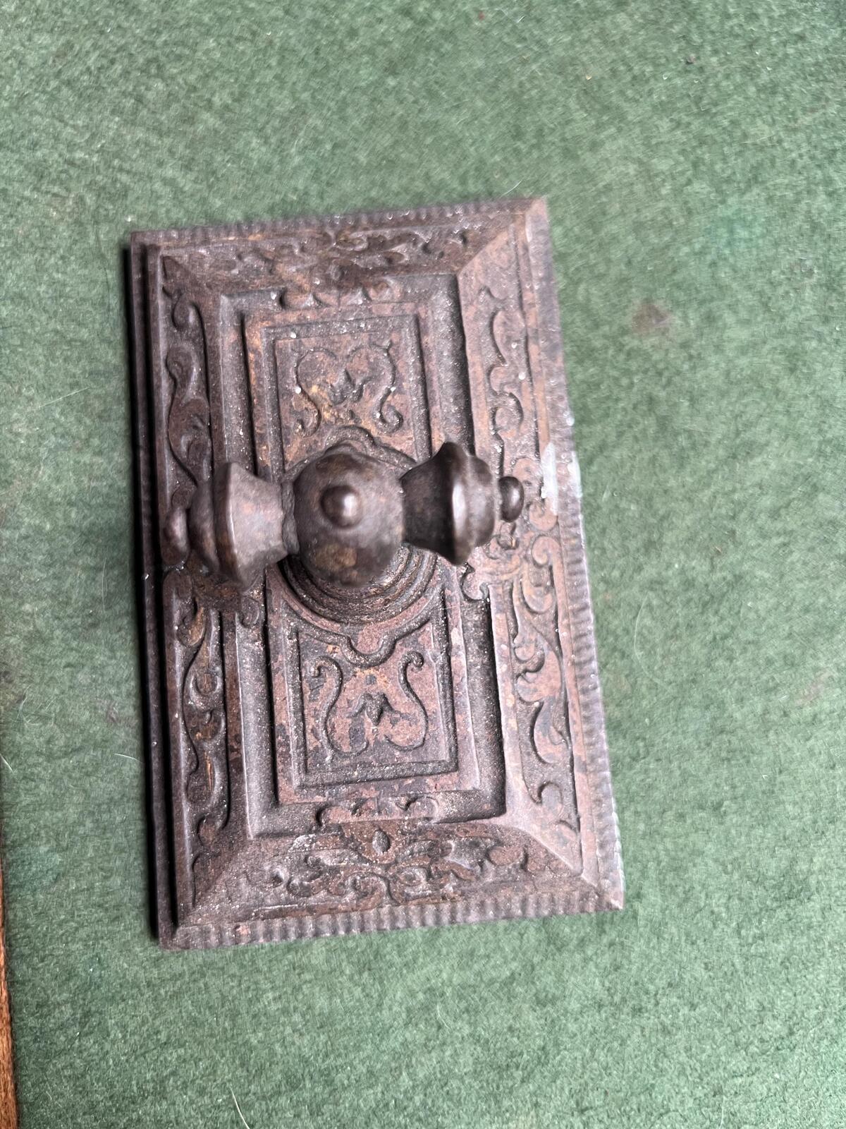 Ornate antique cast iron paperweight. Handled Victorian paperweight doorstop. Decorative pyramid swirl patterned quirky paperweight.
