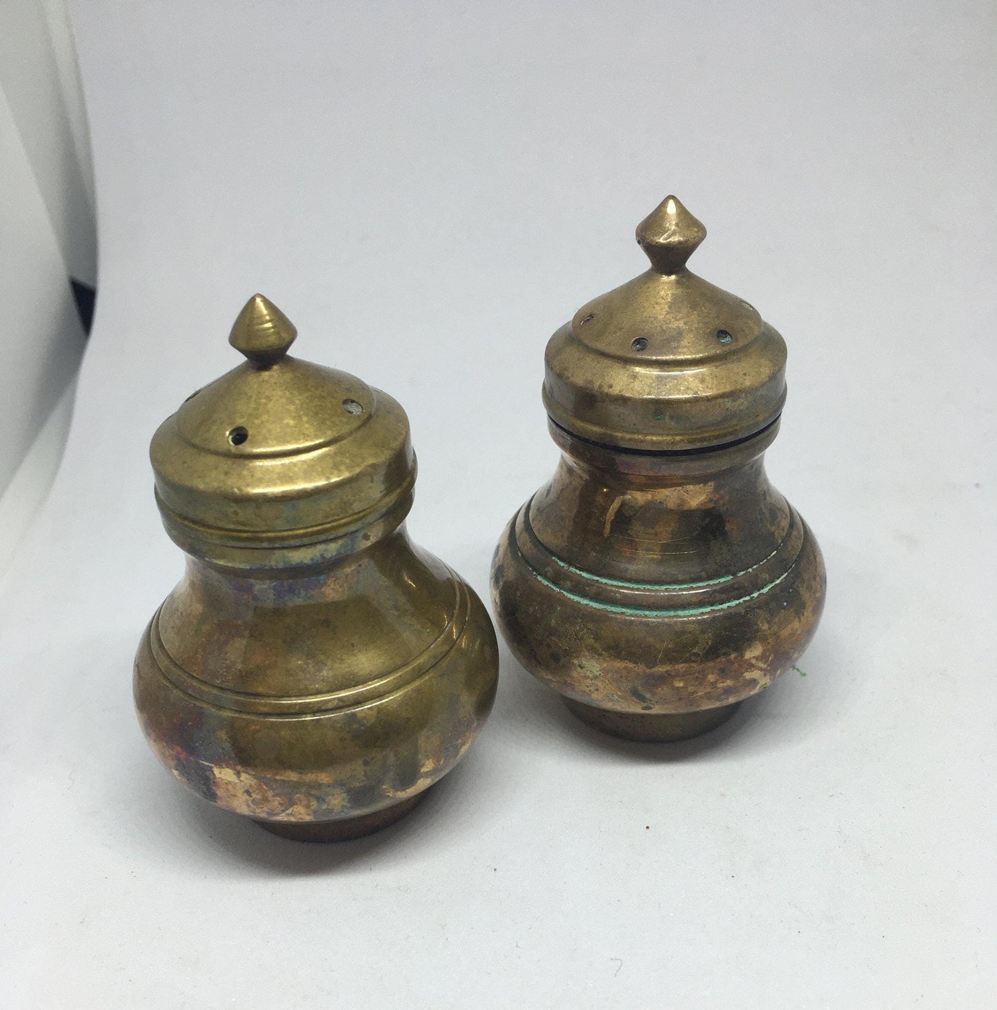 Unusual brass salt and pepper shakers. Screw off lids plastic inserts. Some oxidation.