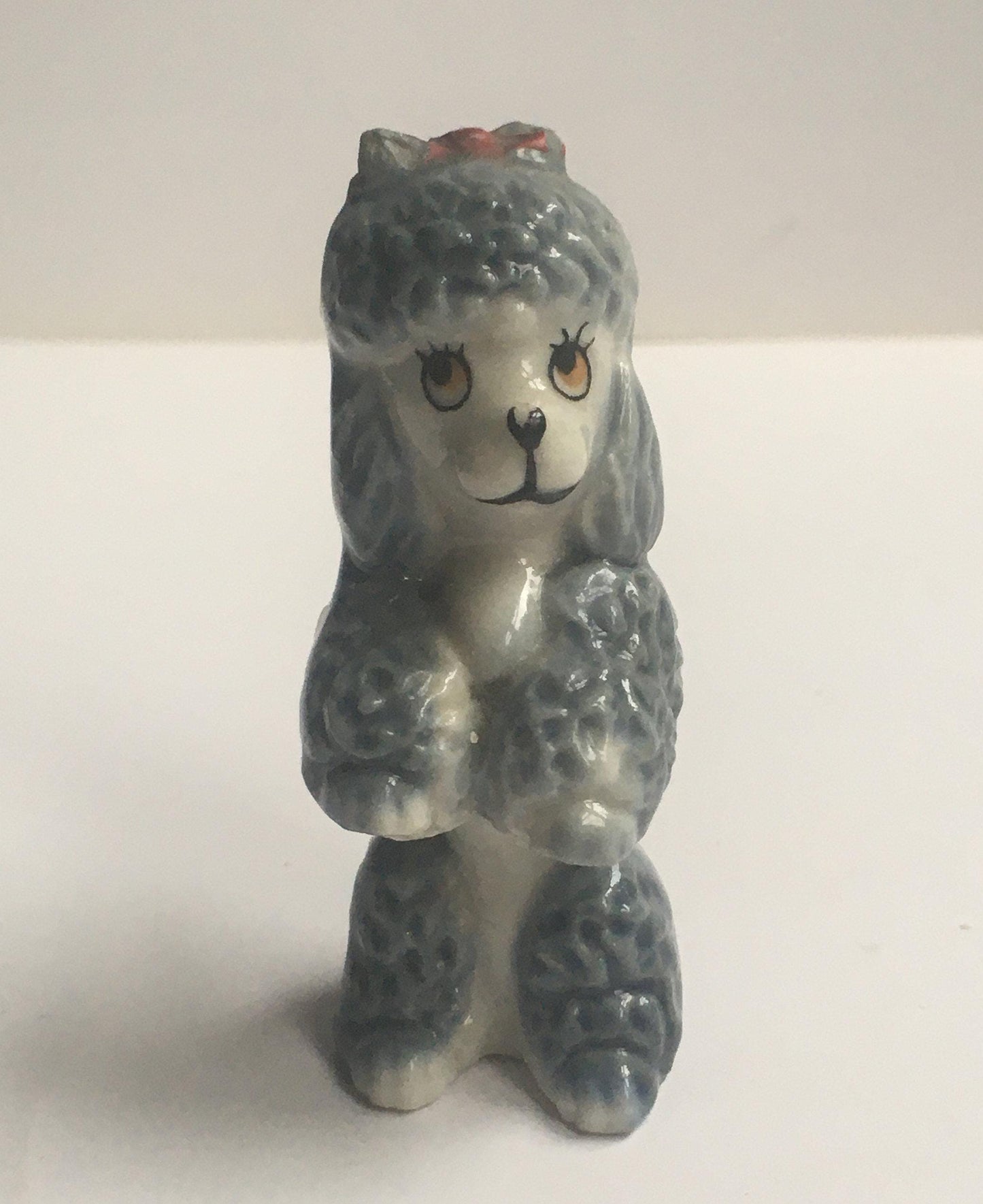 Wade Poodle. Vintage ceramic begging poodle with a red bow.