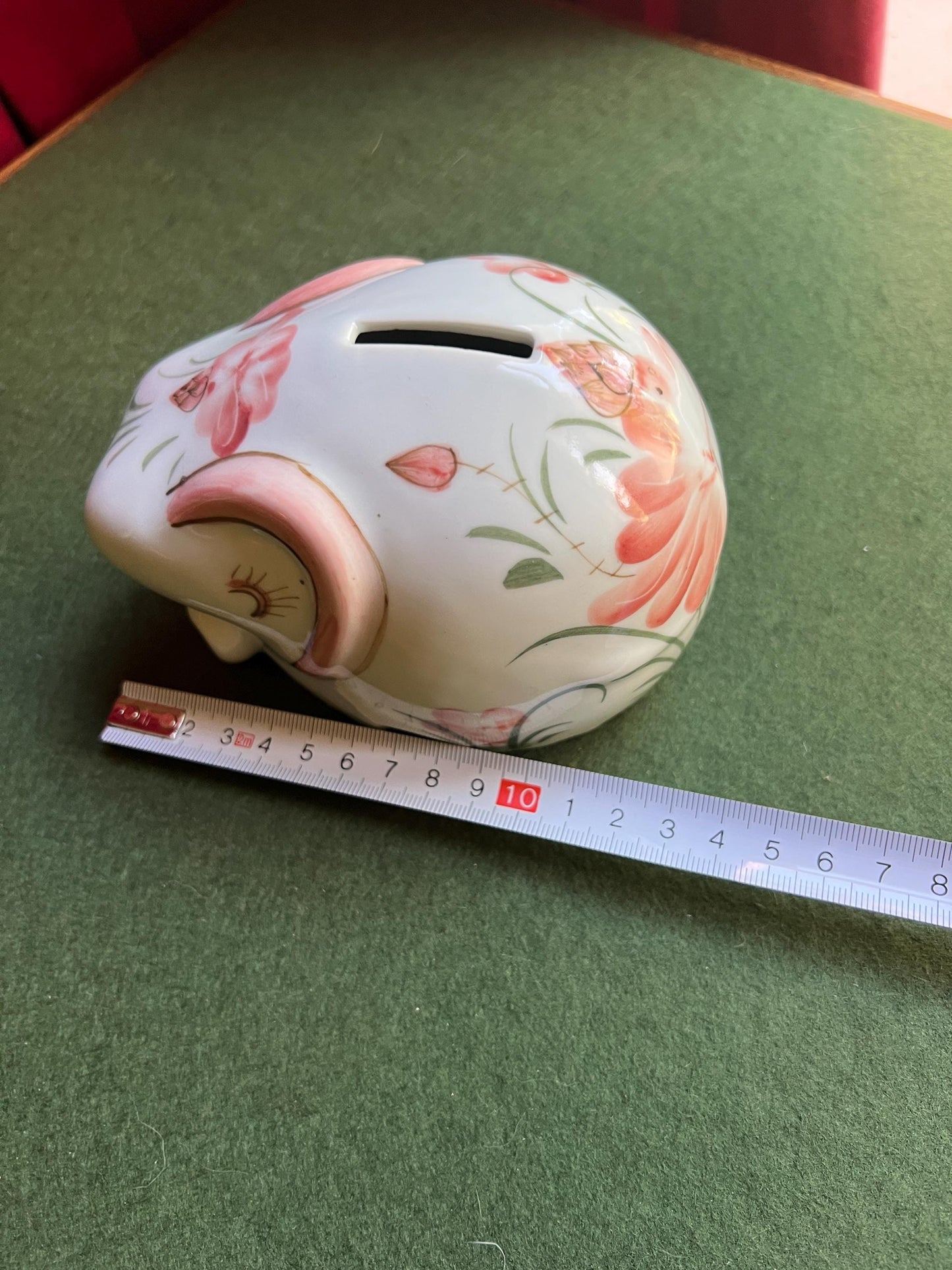 Ceramic elephant money box. Hand painted pink floral design. Made in Thailand.