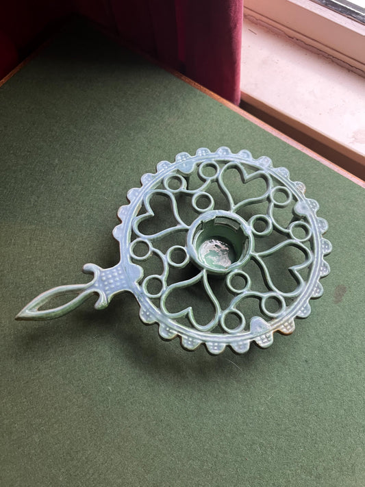 Cast Iron decorative handled green trivet. 4 footed vintage round trivet with votive well.