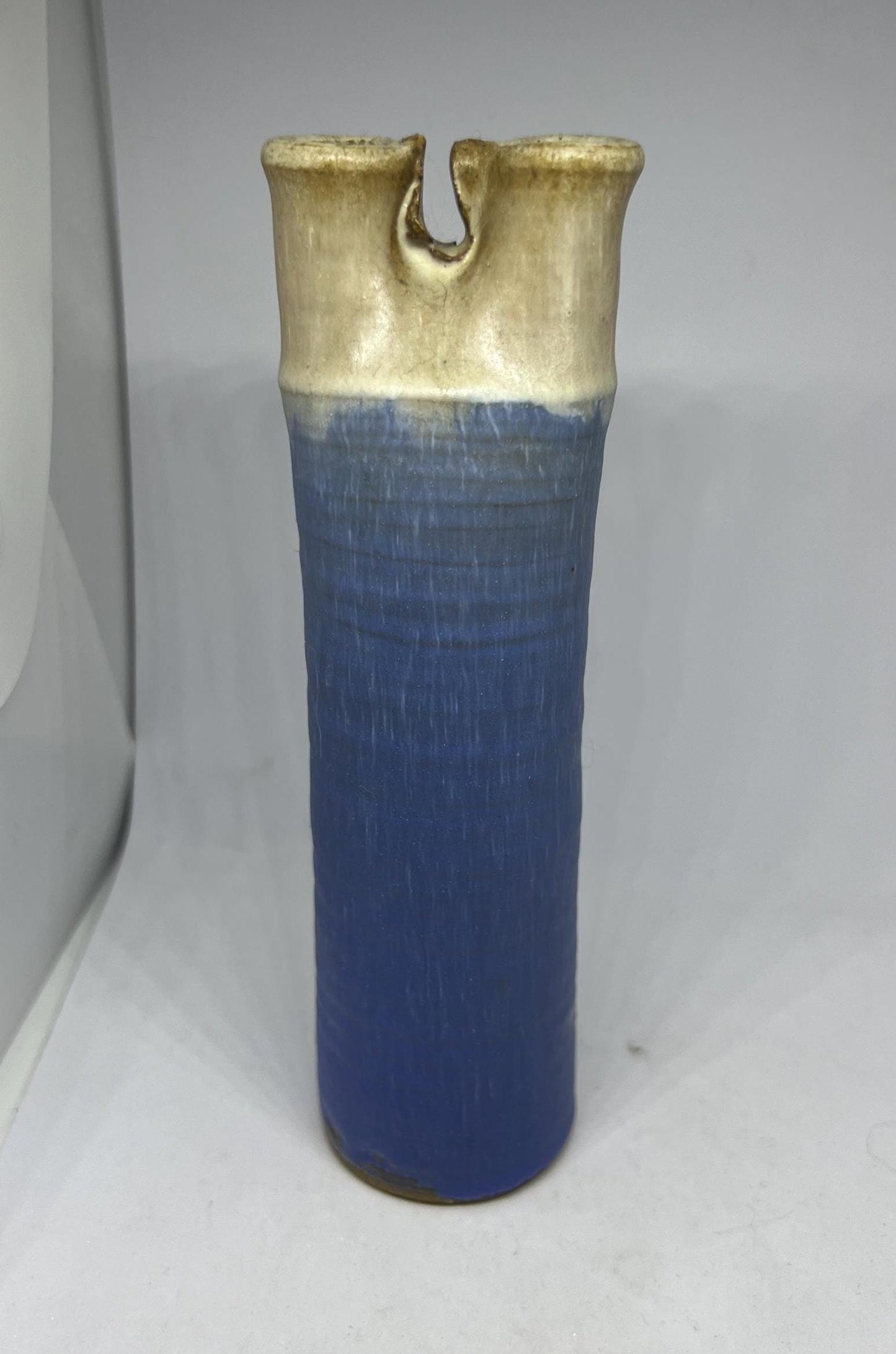 Quirky studio pottery bud vase with blue white glaze.