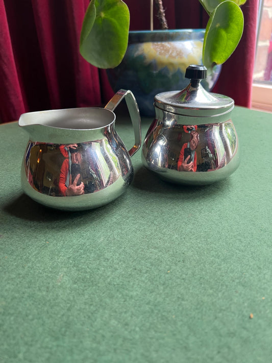 Stainless Steele lidded sugar bowl and creamer. Stamped Bramah of Sheffield Made in England.