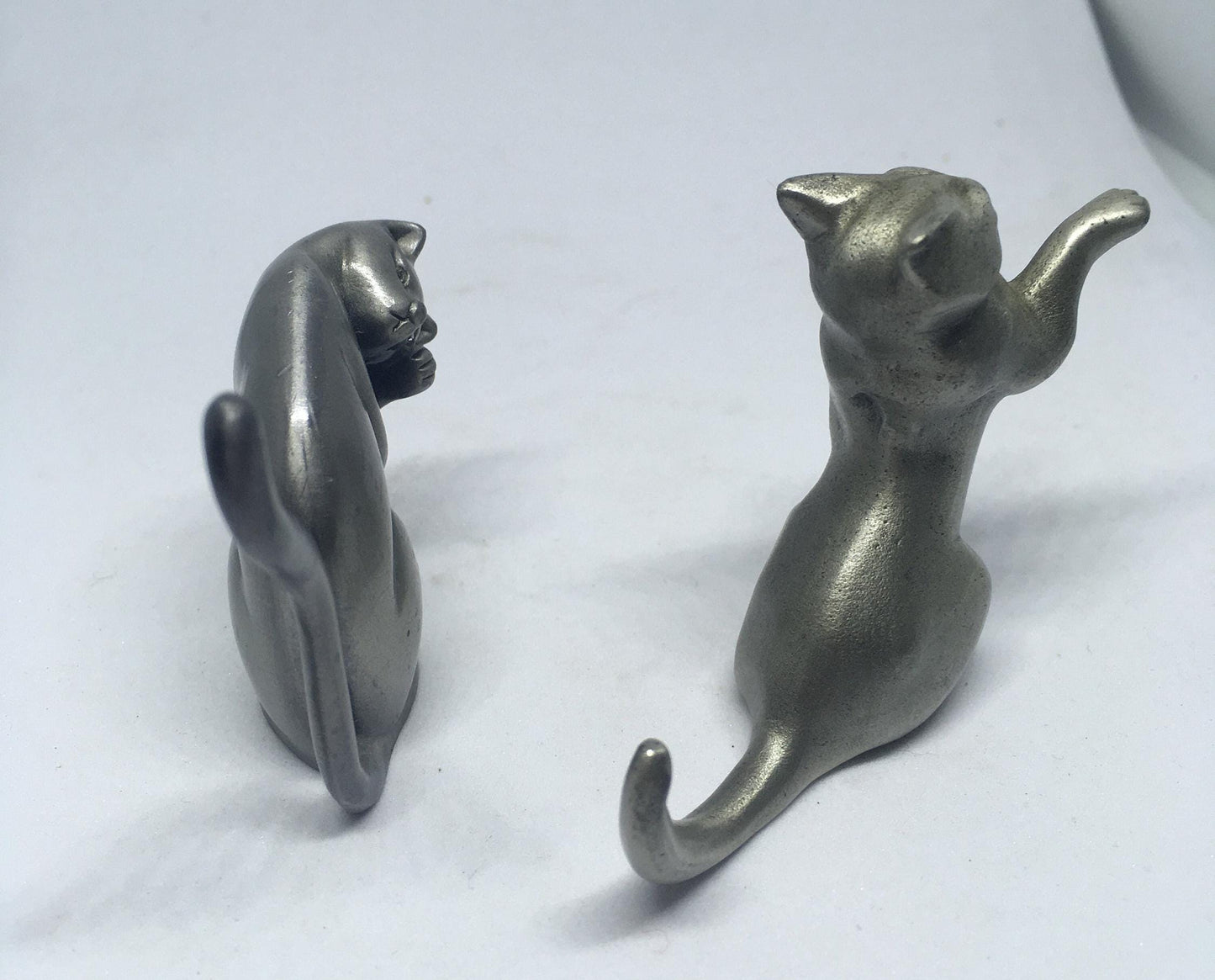 Two pewter cats.