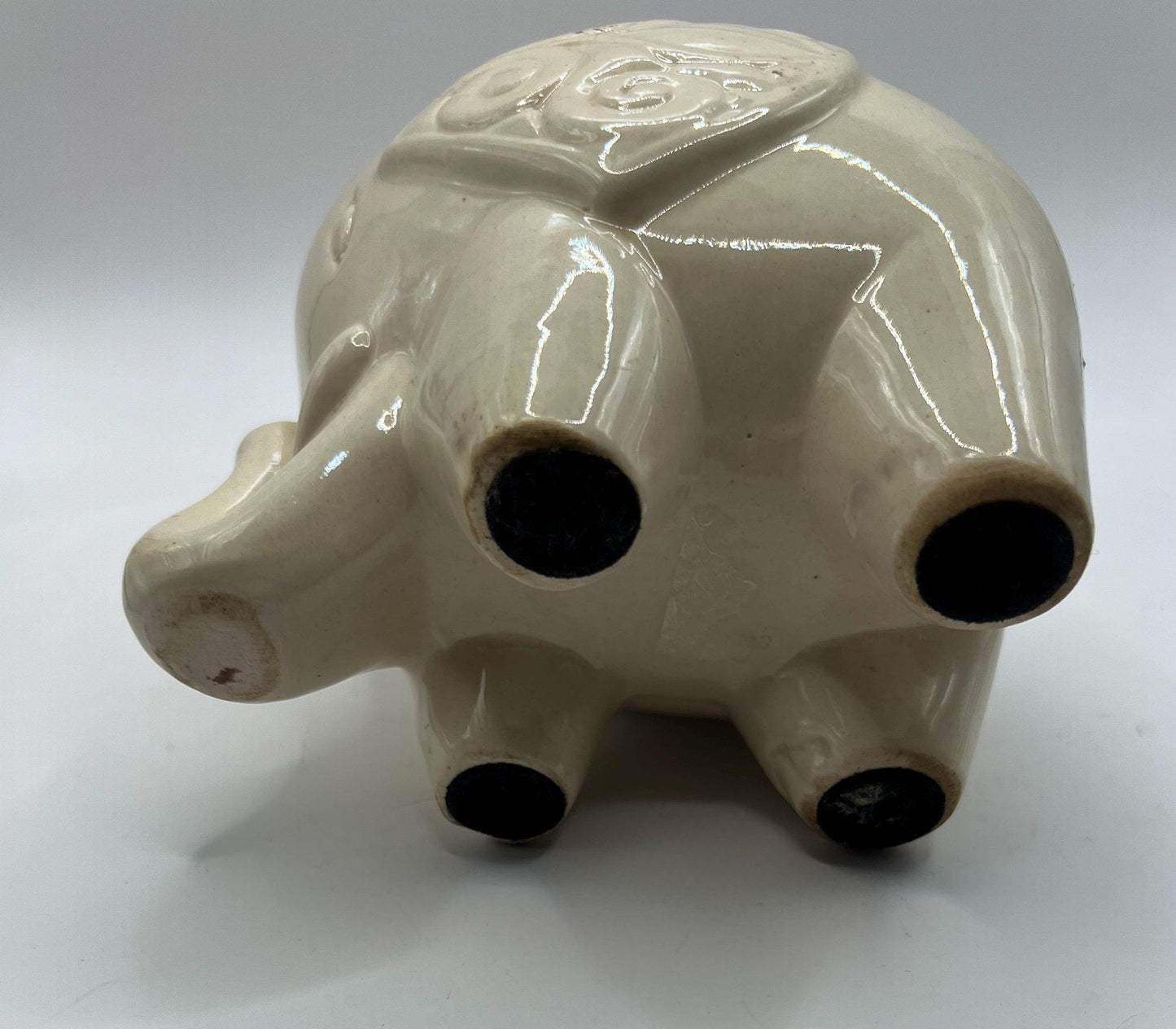 Quirky ceramic elephant figurine with decorated ears.