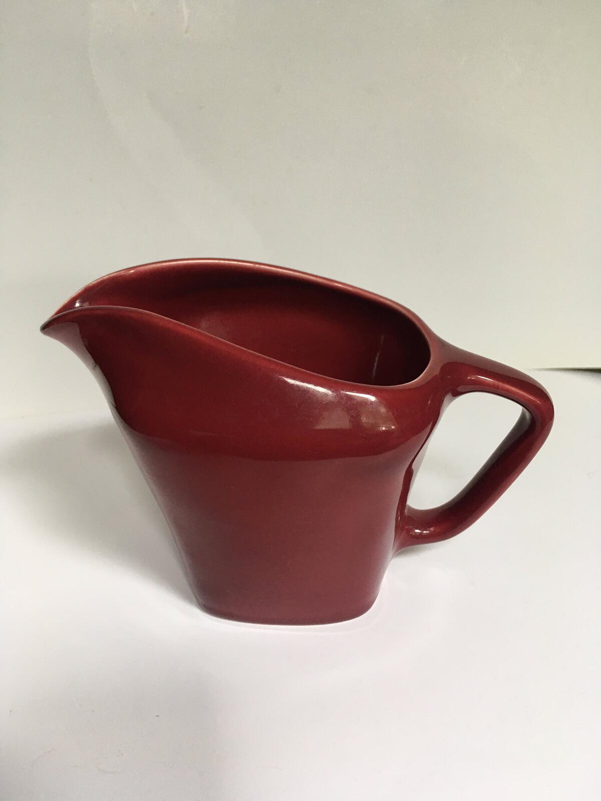 Deep red glazed gravy custard serving jug. Stamped South Seas JG Meakin.