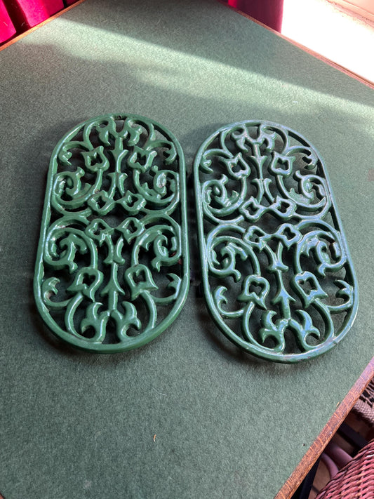 Vintage cast iron trivets. Large Oval green 4 footed trivets. 2 available. Sold separately.