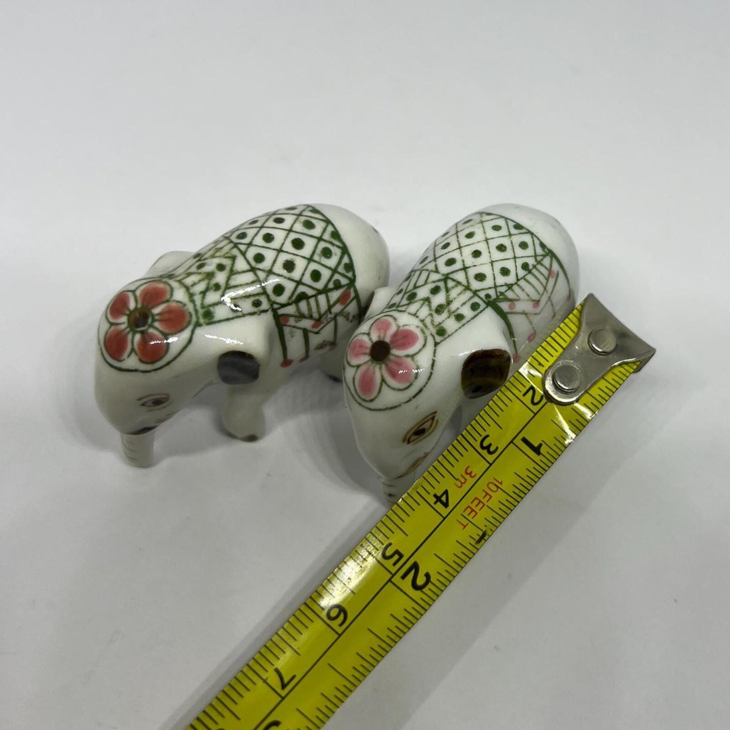 Tiny pair ceramic elephants. Mini ceremonial dress with floral headdress