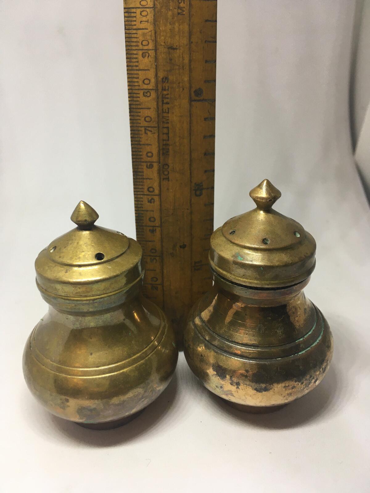 Unusual brass salt and pepper shakers. Screw off lids plastic inserts.