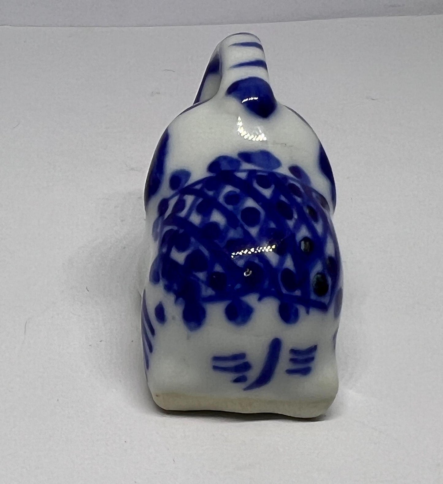 Blue white ceramic elephant figurine. Lucky trunk up sitting elephant ornament.
