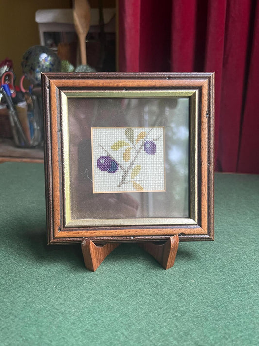 Hand stitched plum framed embroidery picture. Danish textile art gallery wall decor. Fruit theme textile arts.
