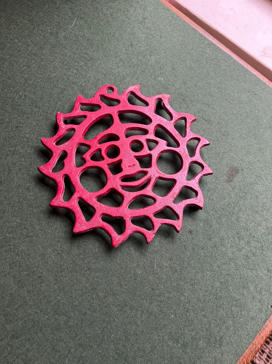 Cast Iron decorative red trivet. 4 footed vintage sun shaped trivet.
