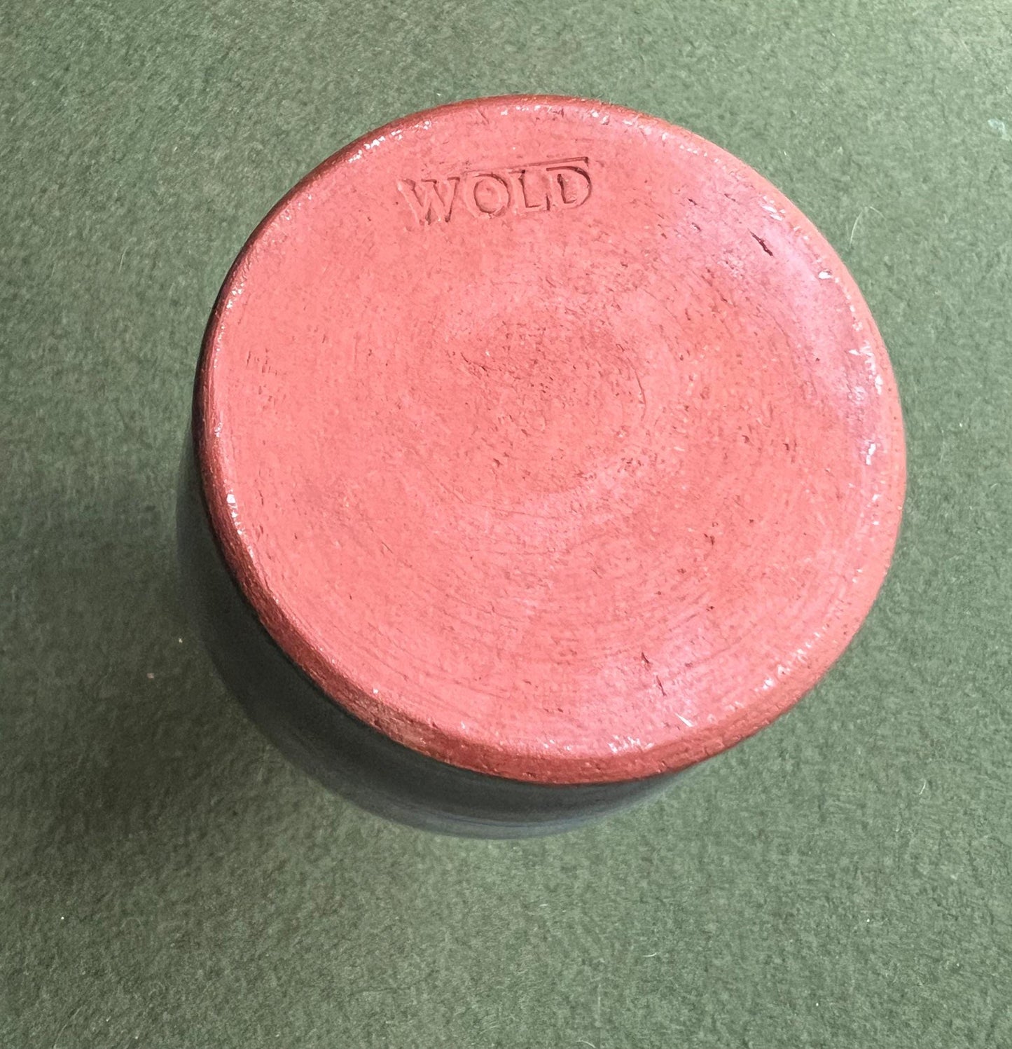 Beautiful vintage studio pottery vase. Blue glaze with black swirl and red rim. Stamped WOLD