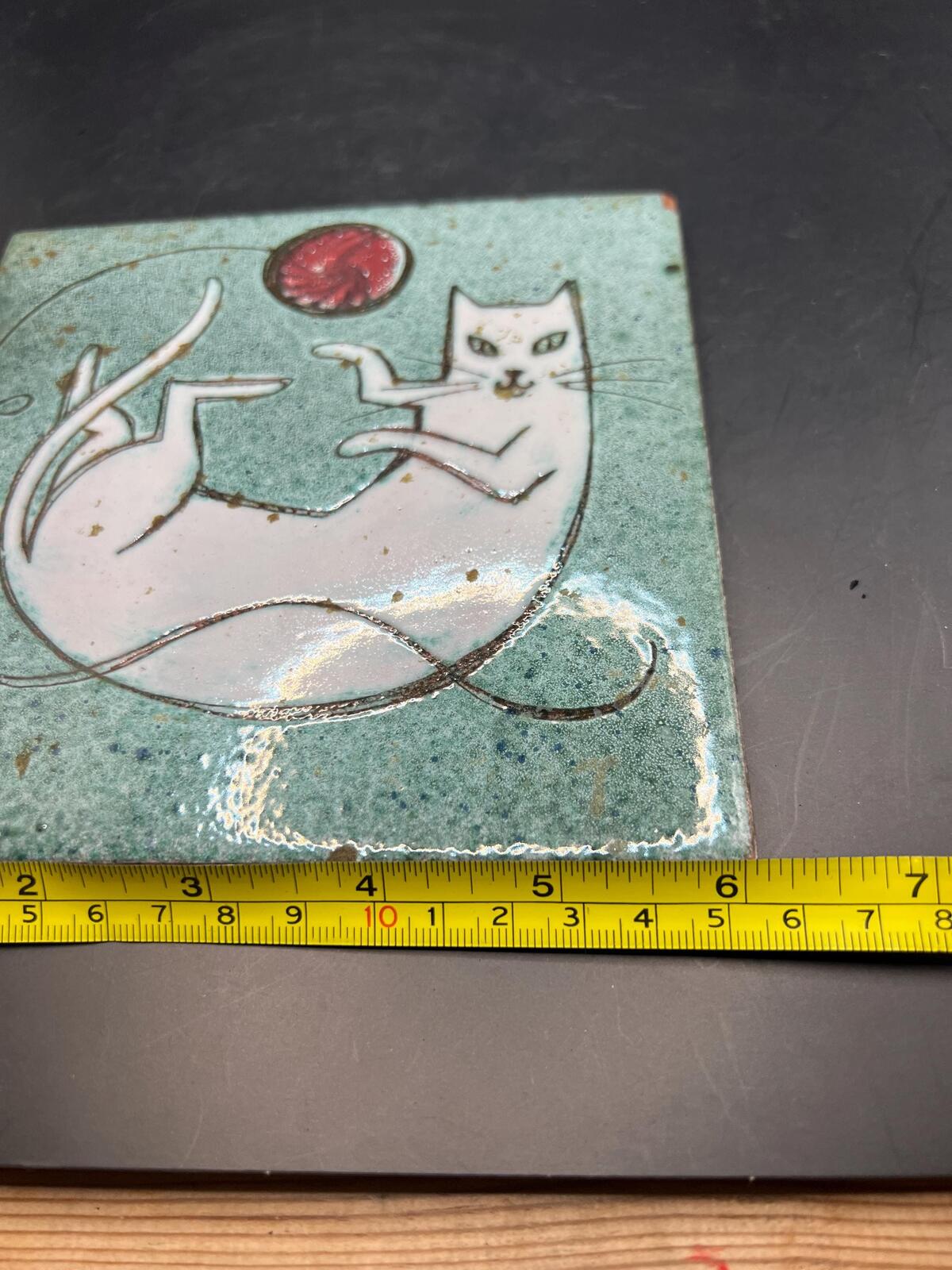 Hand made Cat tile signed Christina Shepherd original. White cat playing with a red balloon.