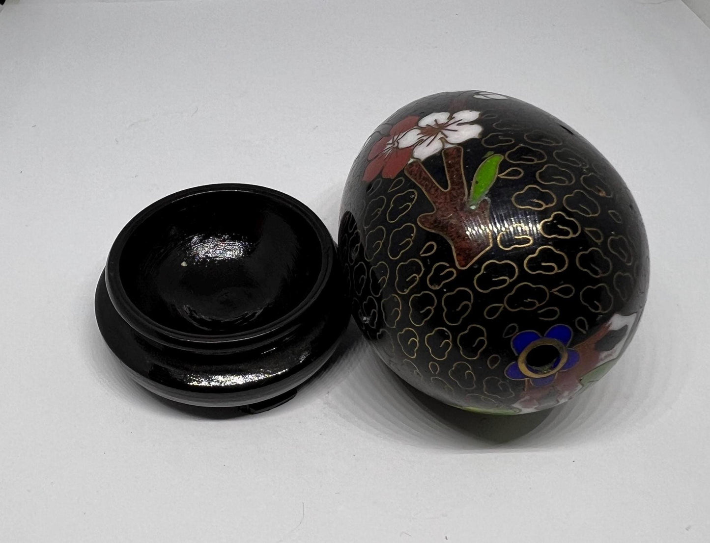 Vintage cloisonne egg with stand. Stunning floral design on black enamel background.