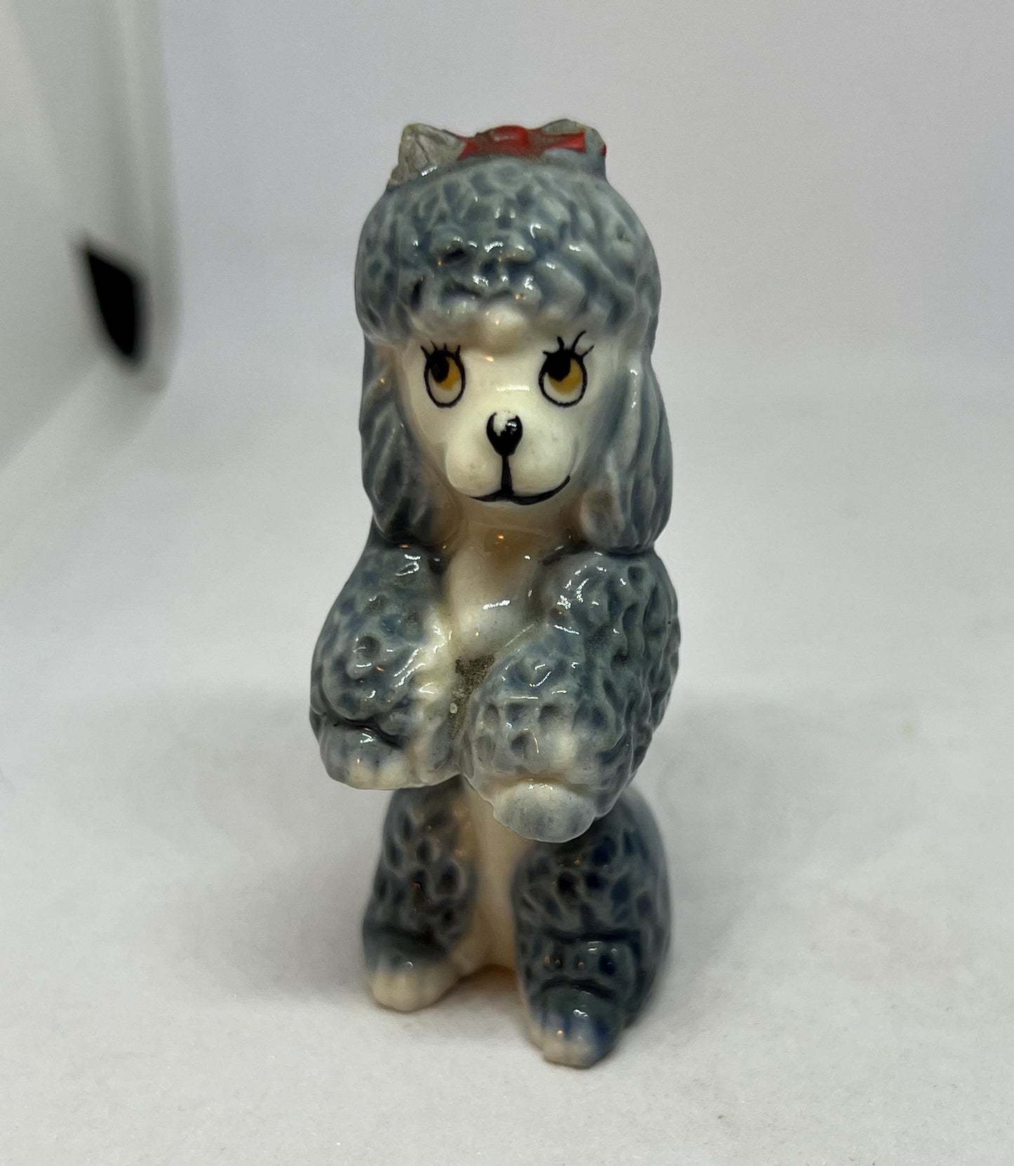 Wade Poodle. Vintage ceramic begging poodle with a red bow.