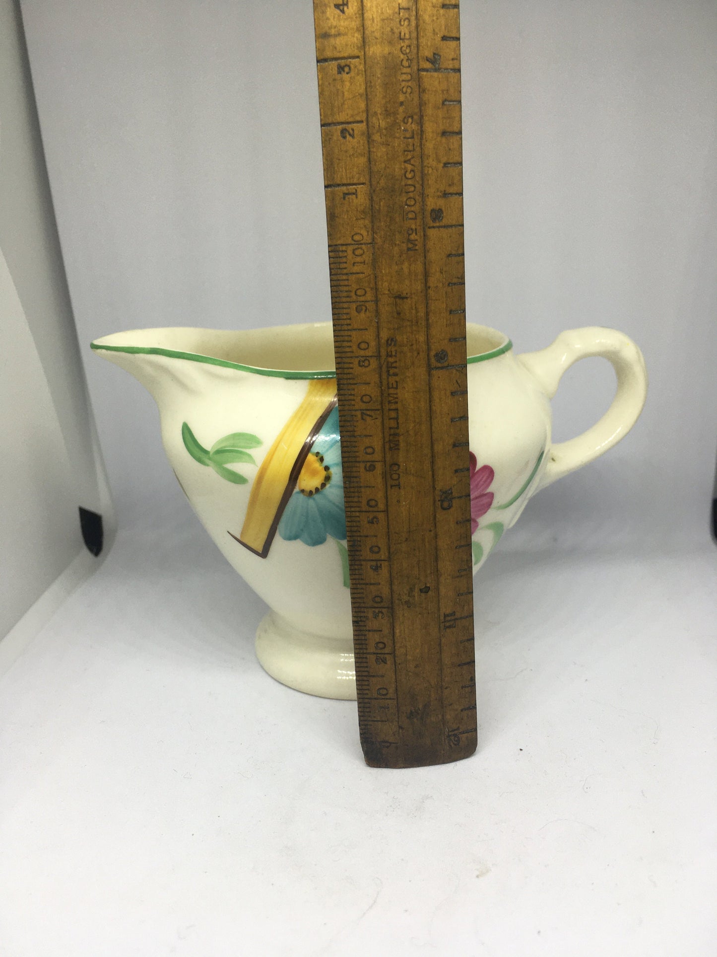 Ceramic hand painted milk jug. Stamped Ainsley England.