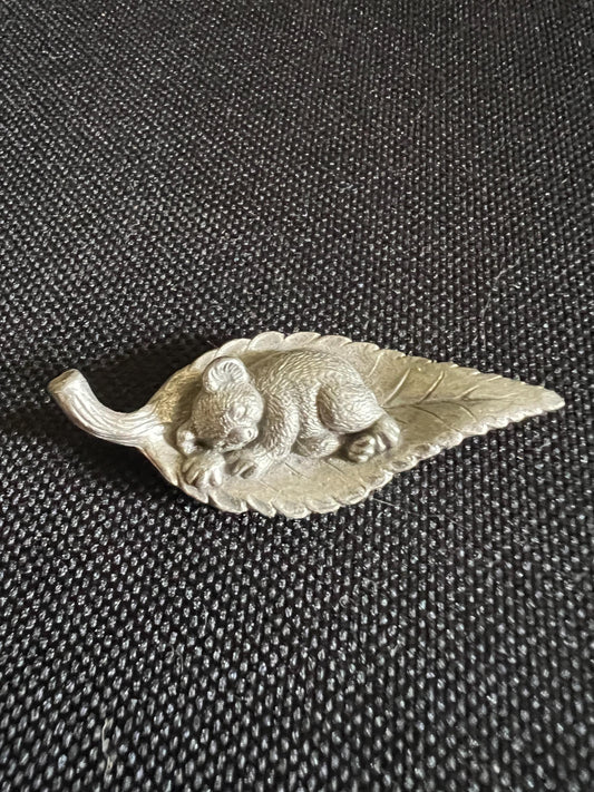Tiny koala sleeping on a leaf. Pewter miniature figurine.
