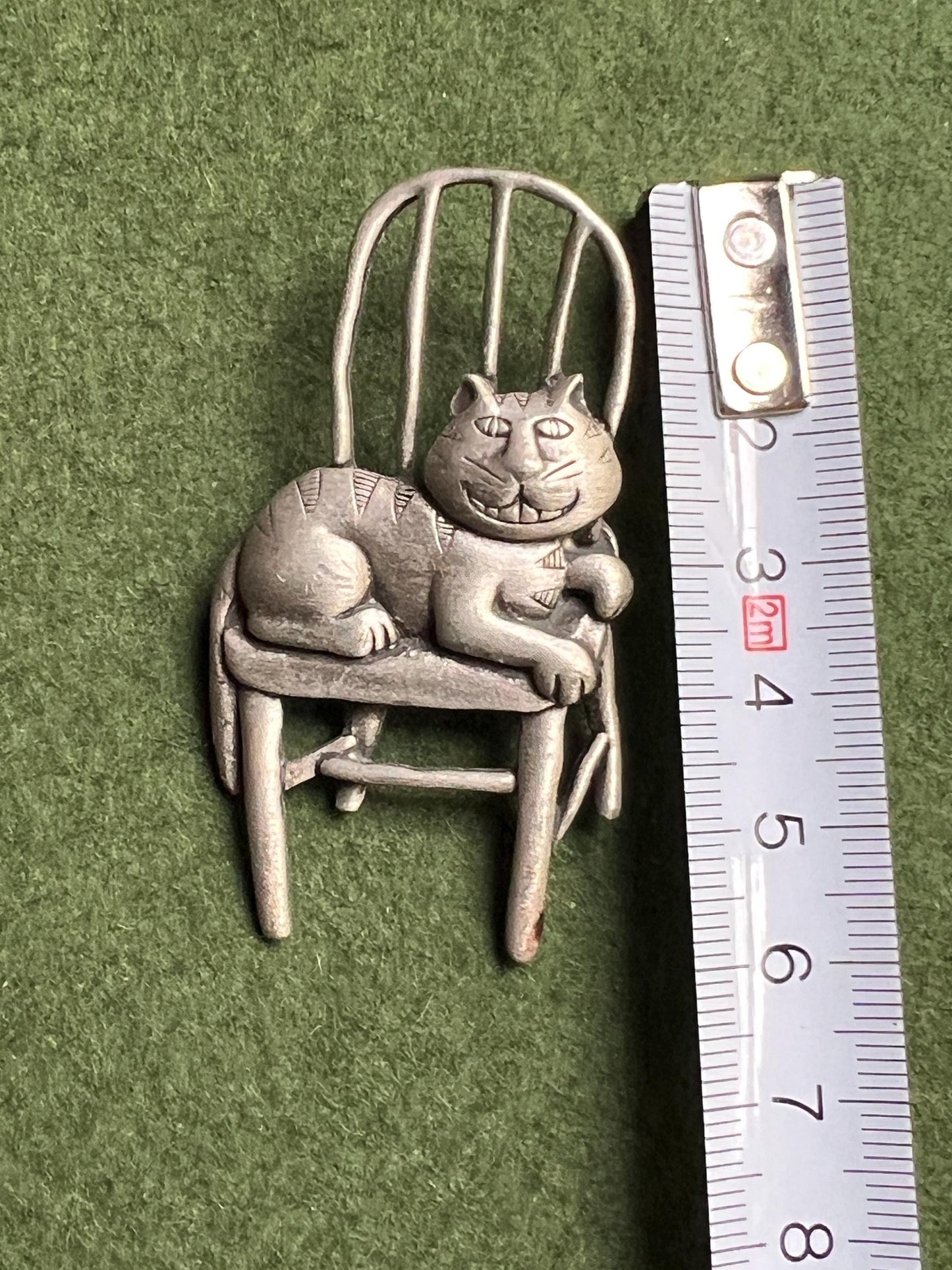 Vintage Cat brooch Signed JJ. Grinning Cheshire Cat sitting on a chair.