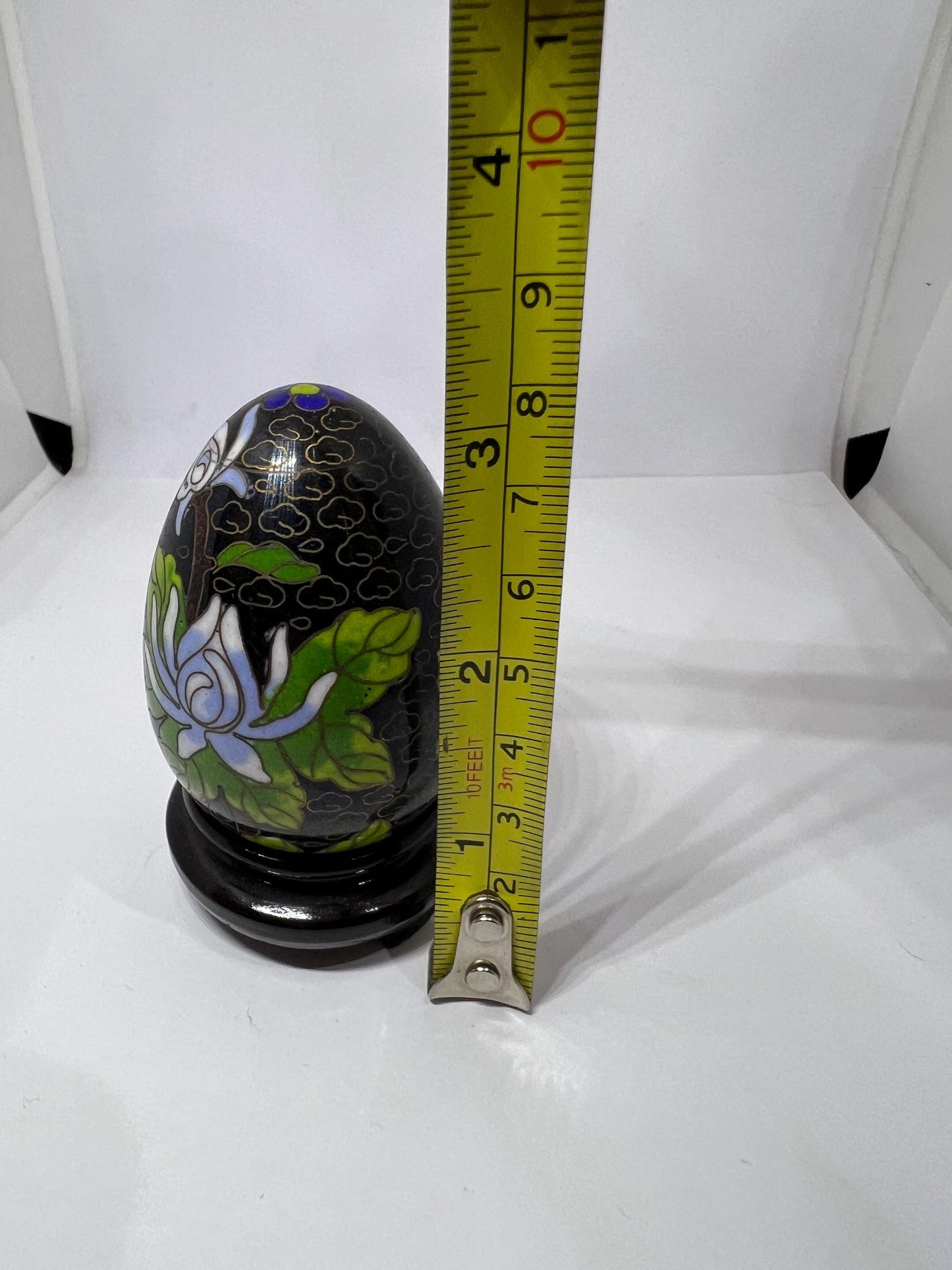 Vintage cloisonne egg with stand. Stunning floral design on black enamel background.