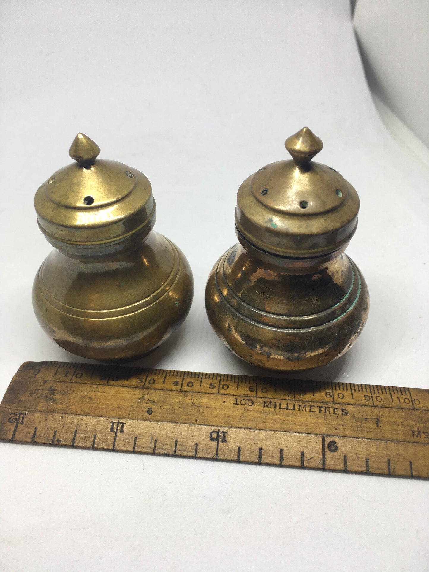 Unusual brass salt and pepper shakers. Screw off lids plastic inserts. Some oxidation.