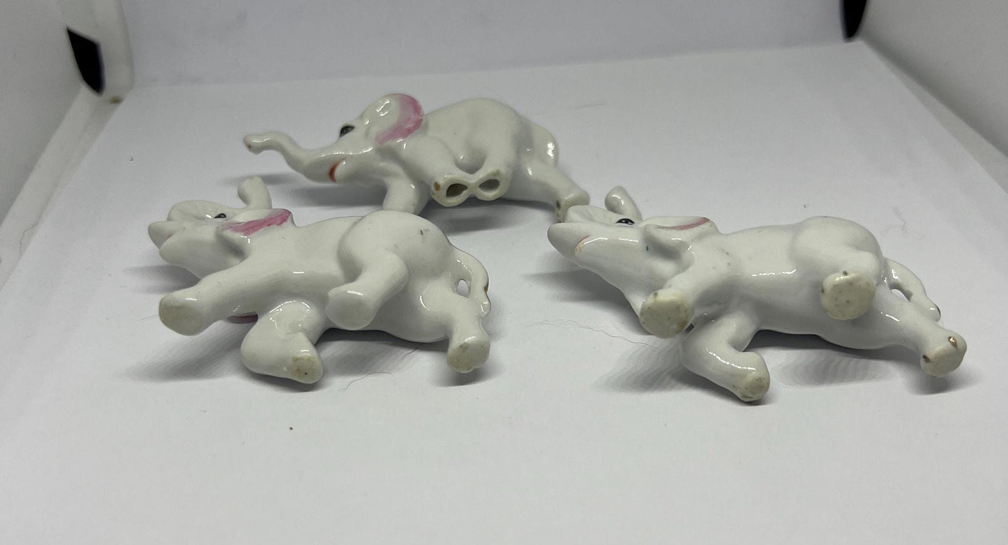 Ceramic elephant family. Lucky trunks raised mum dad and baby elephant collection.