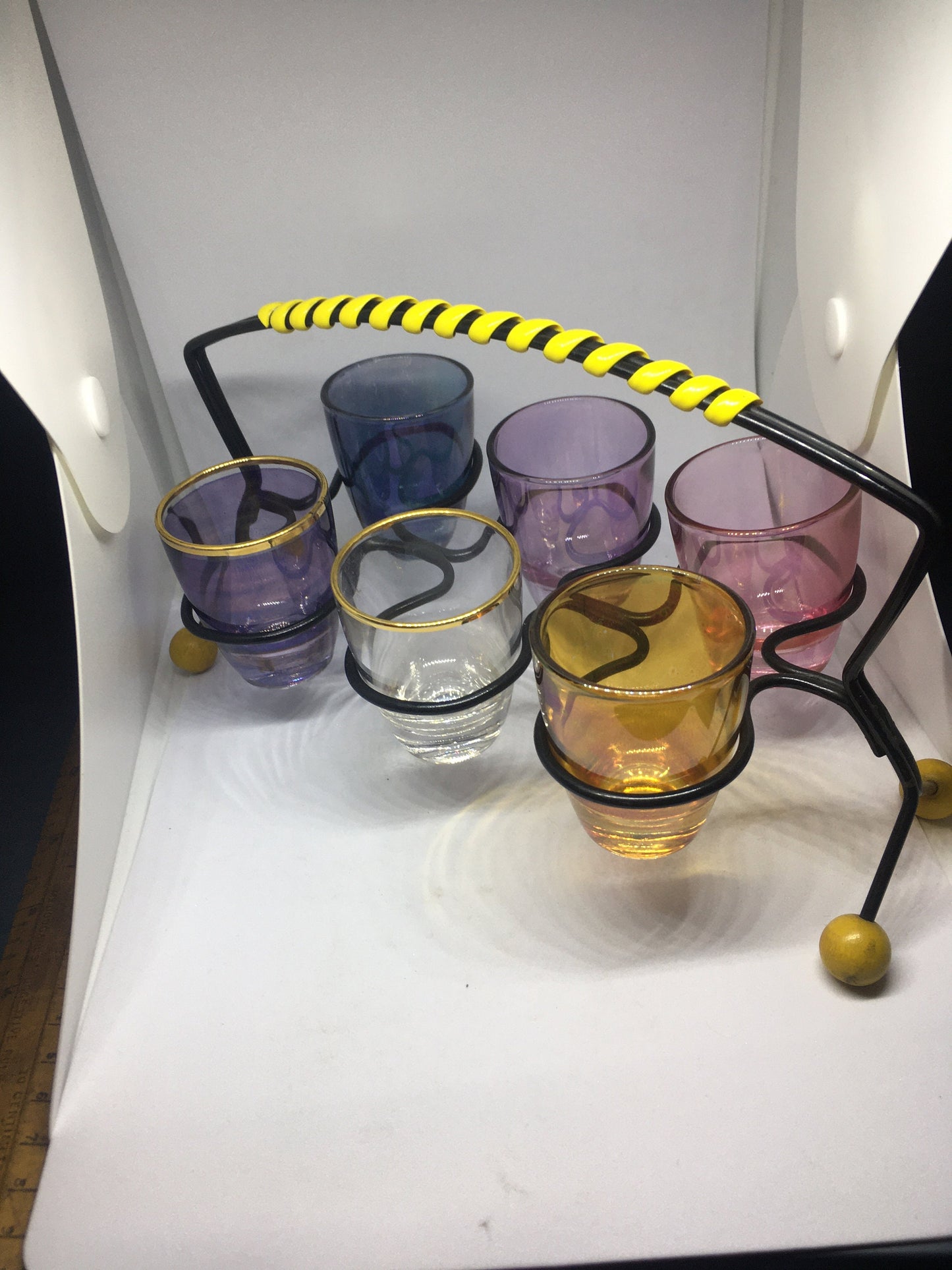 1950s Harlequin glass 6 shot glasses in wire holder.