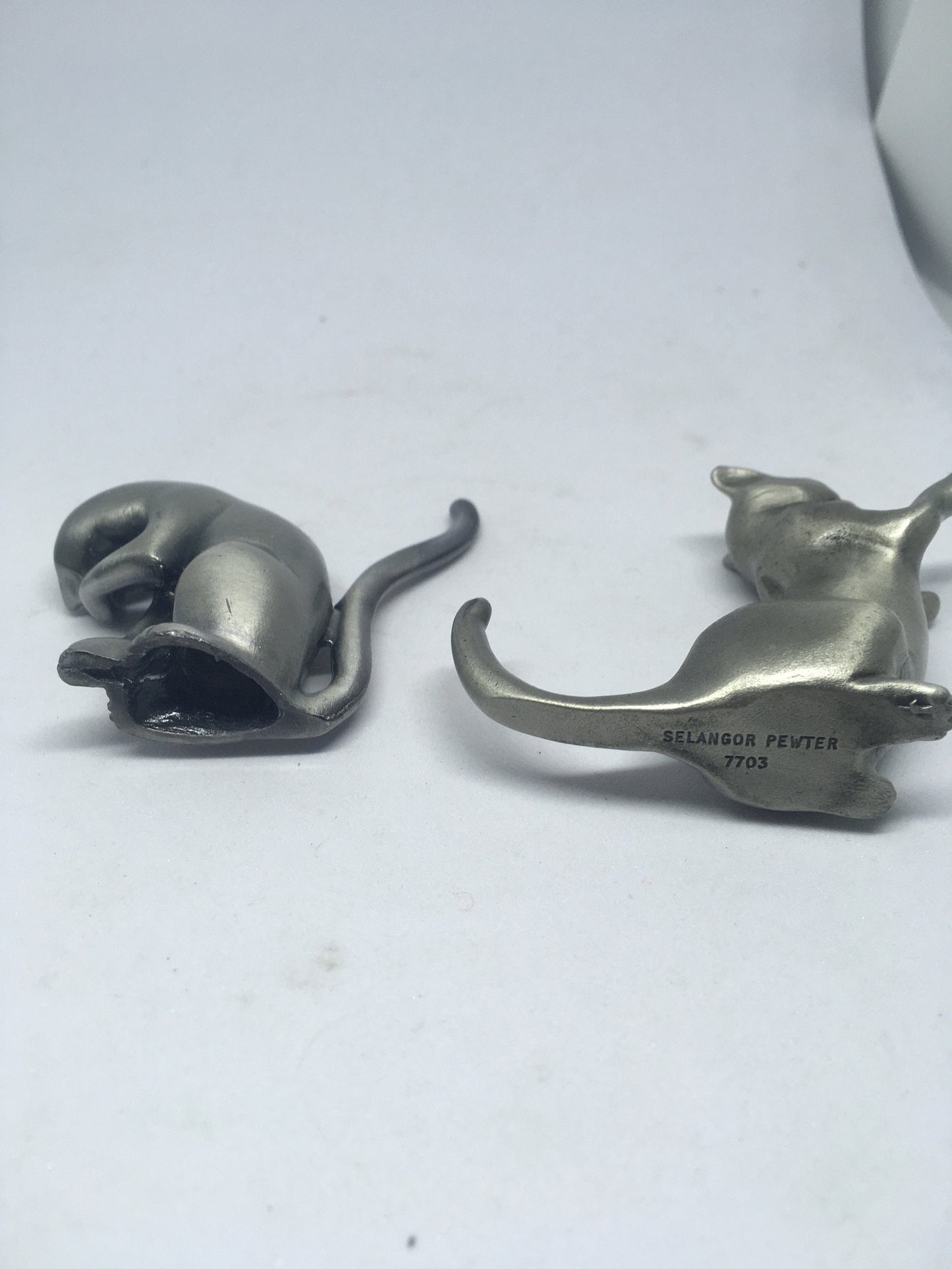 Two pewter cats.