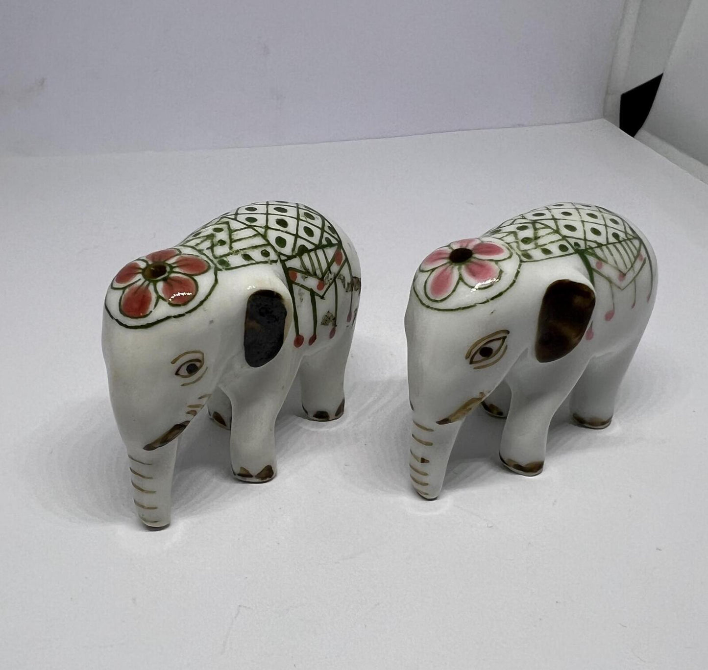 Tiny pair ceramic elephants. Mini ceremonial dress with floral headdress