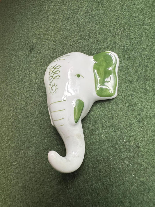 Vintage ceramic elephant head wall hanging. Hand painted green details.