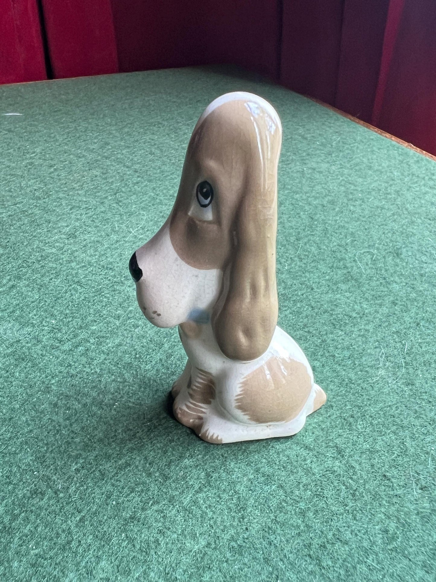 Ceramic sad hound dog figurine. Stamped Szeiler.