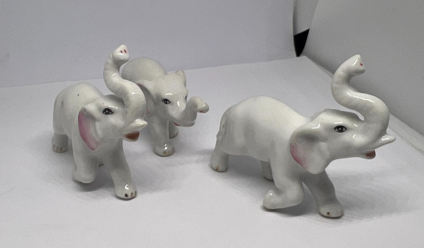 Ceramic elephant family. Lucky trunks raised mum dad and baby elephant collection.