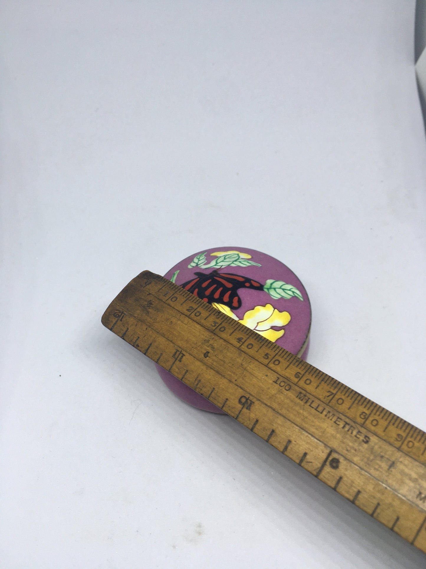 Enamel cloisonne lidded trinket box. Purple enamel with butterfly and flower decoration.