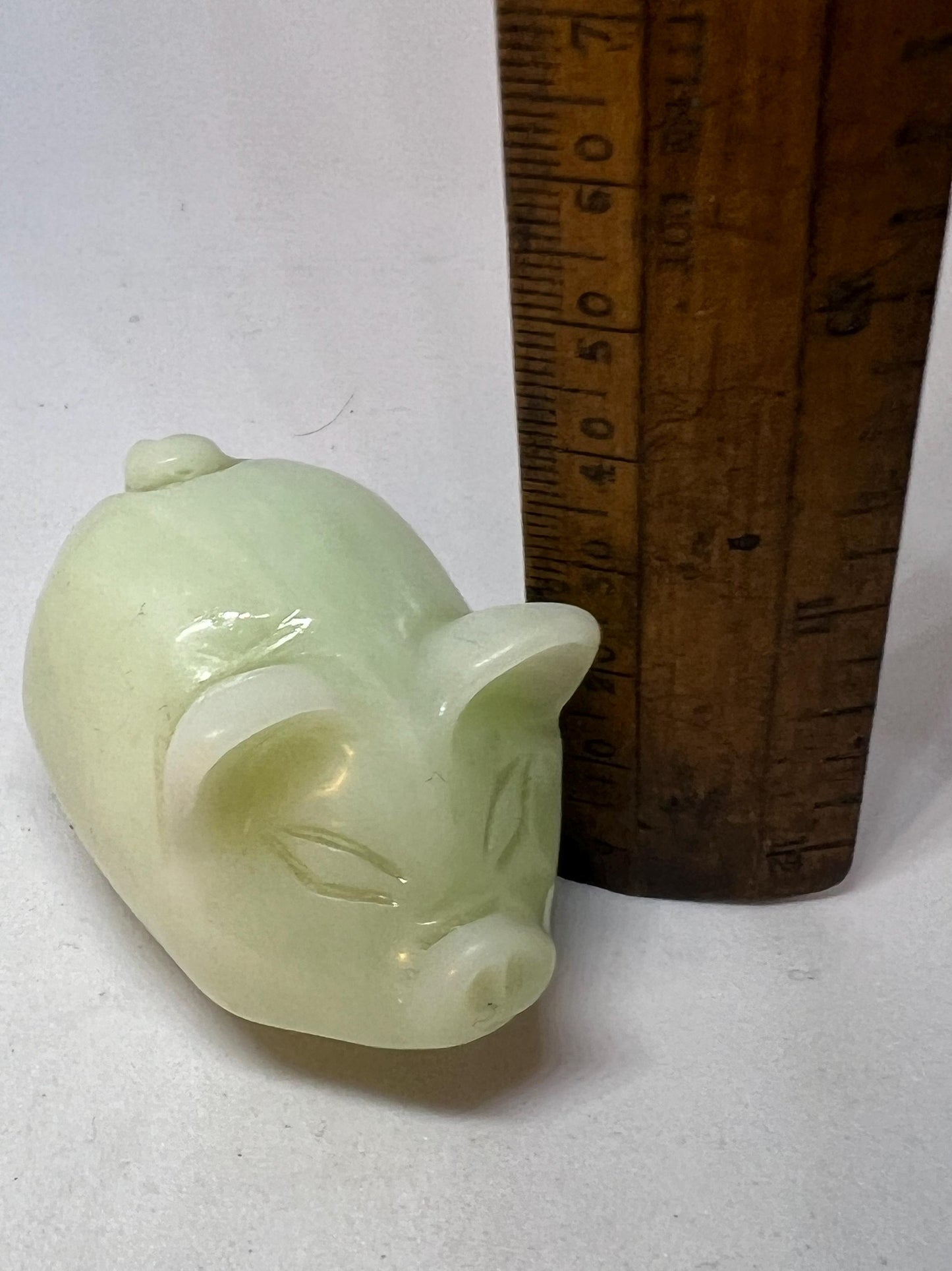 Vintage jade pig figurine. Cute carved white stone jade piglet ornament.