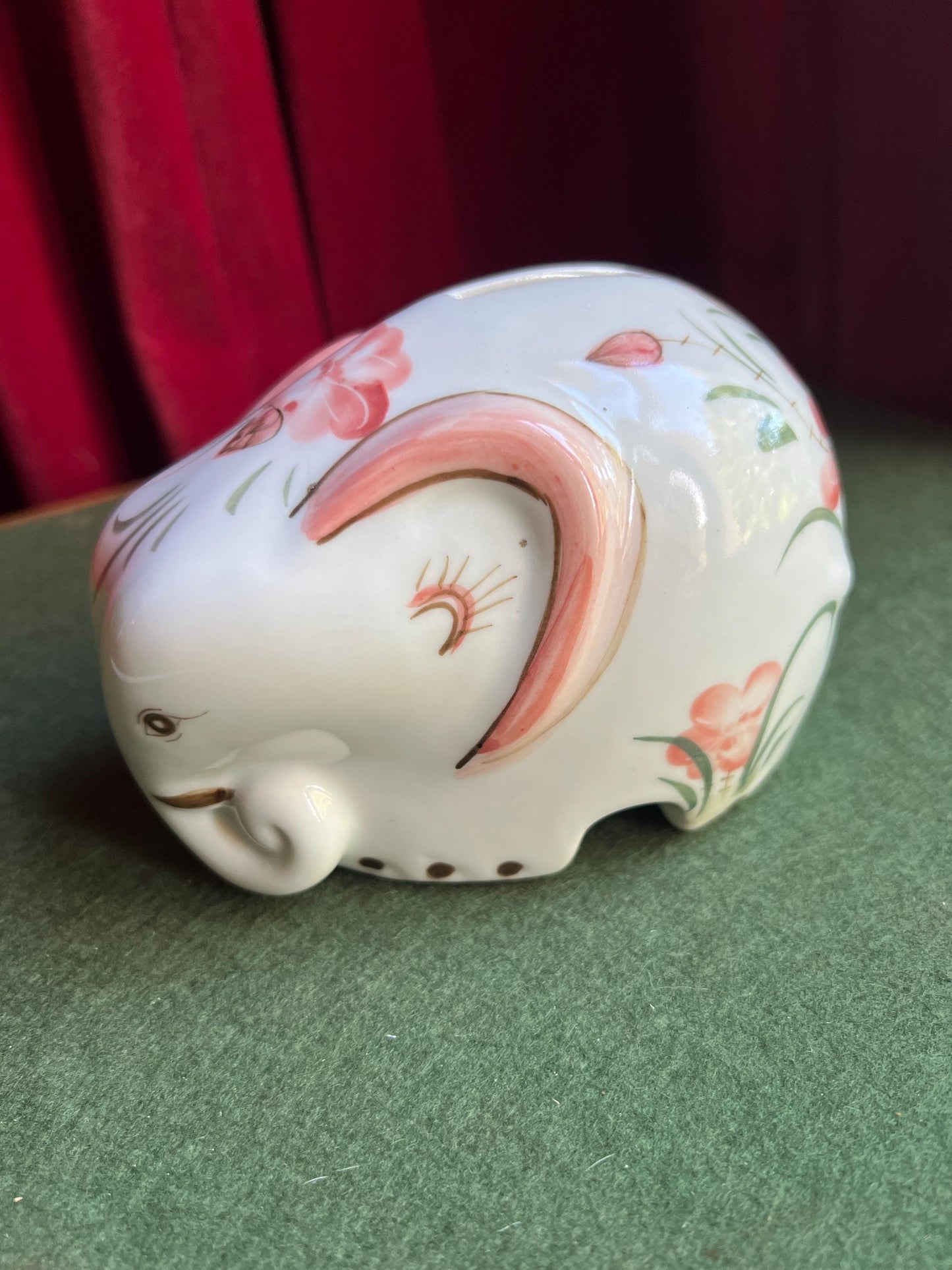 Ceramic elephant money box. Hand painted pink floral design. Made in Thailand.