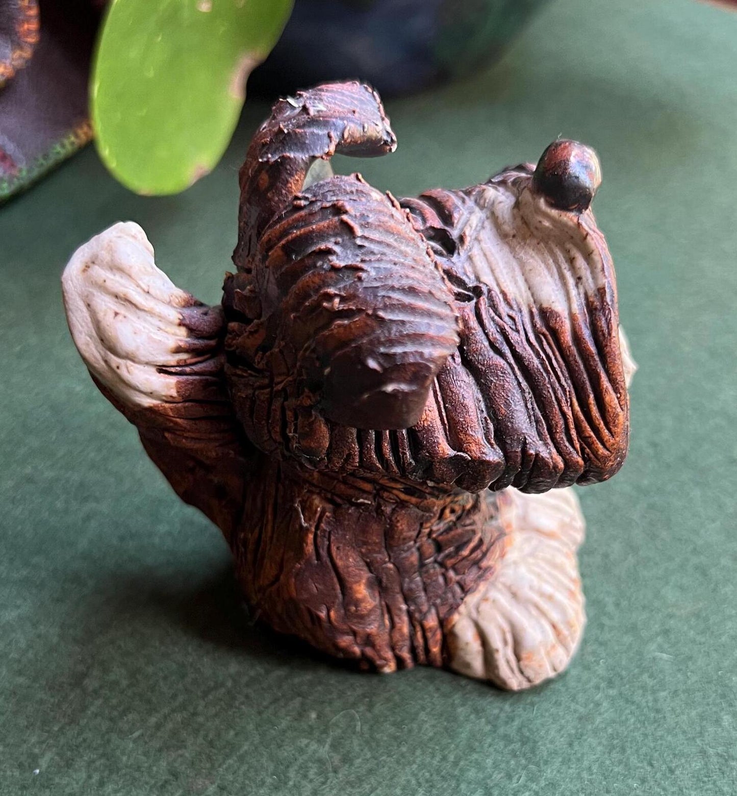 Hand built studio pottery brown glazed dog with its tongue out and quirky ears.