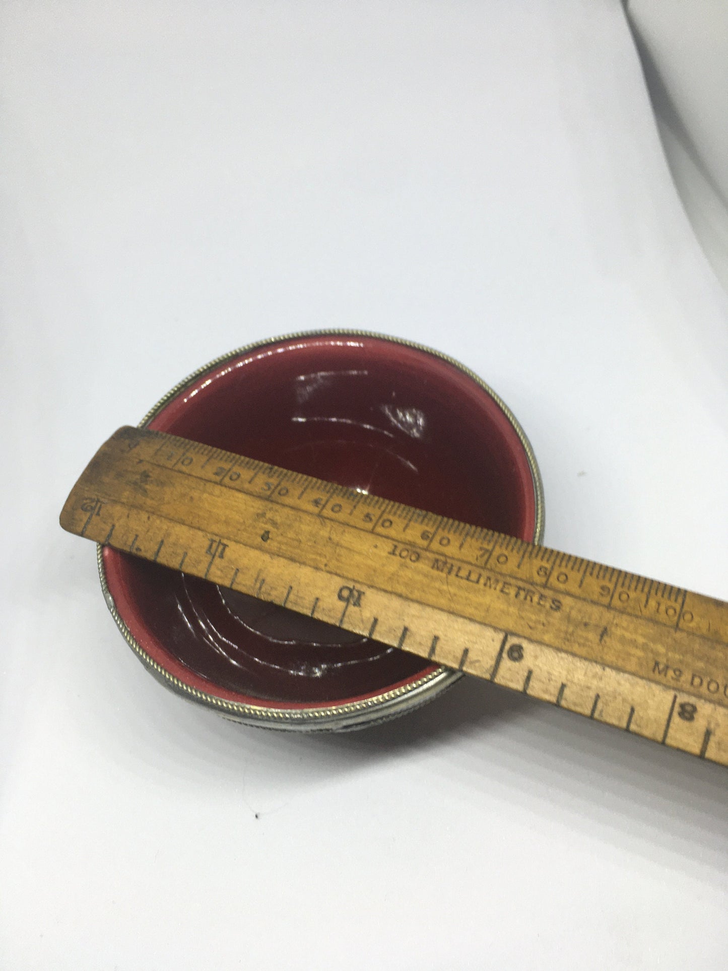Vintage red glazed trinket pin dish with silver tone band.