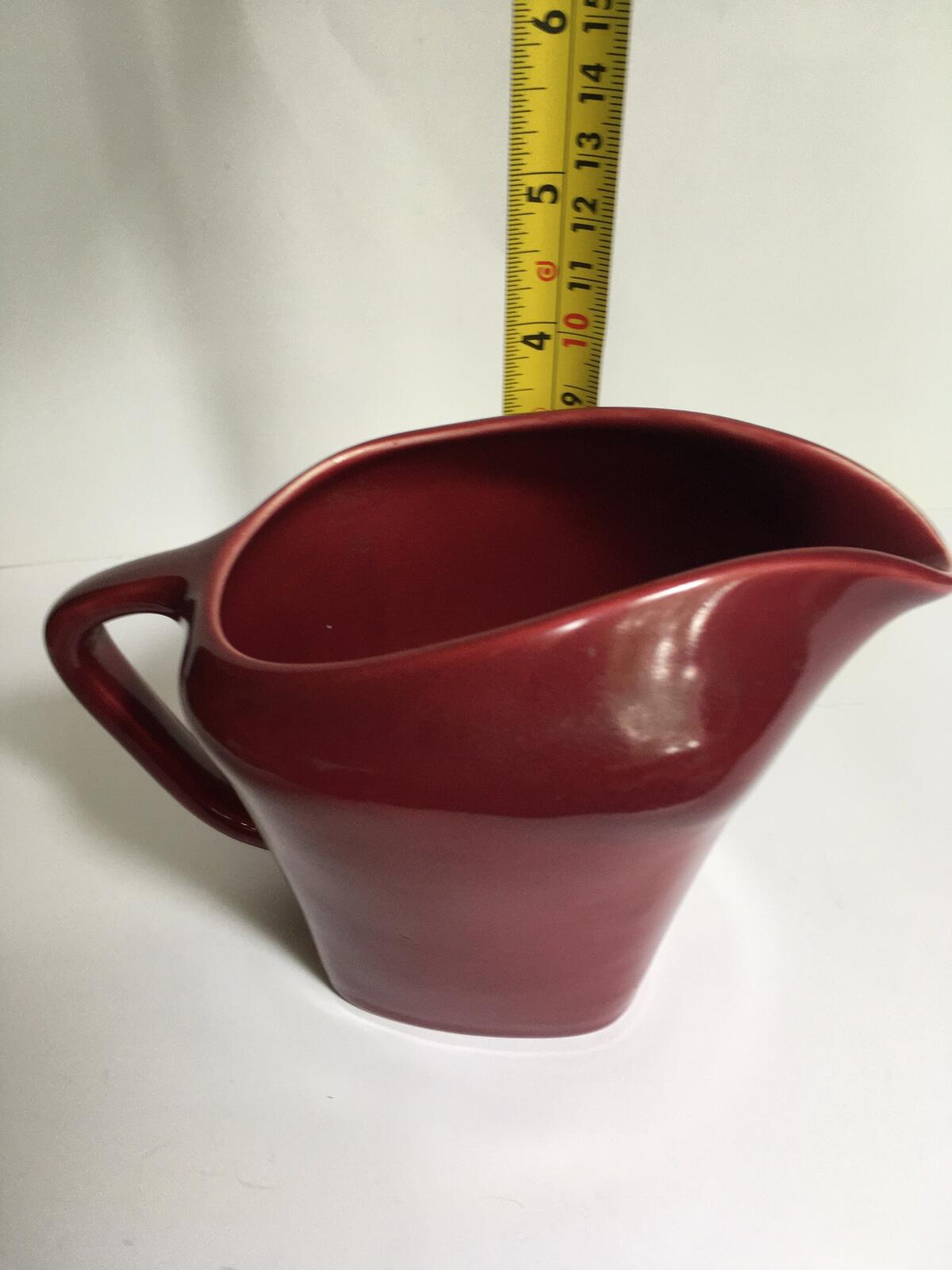 Deep red glazed gravy custard serving jug. Stamped South Seas JG Meakin.
