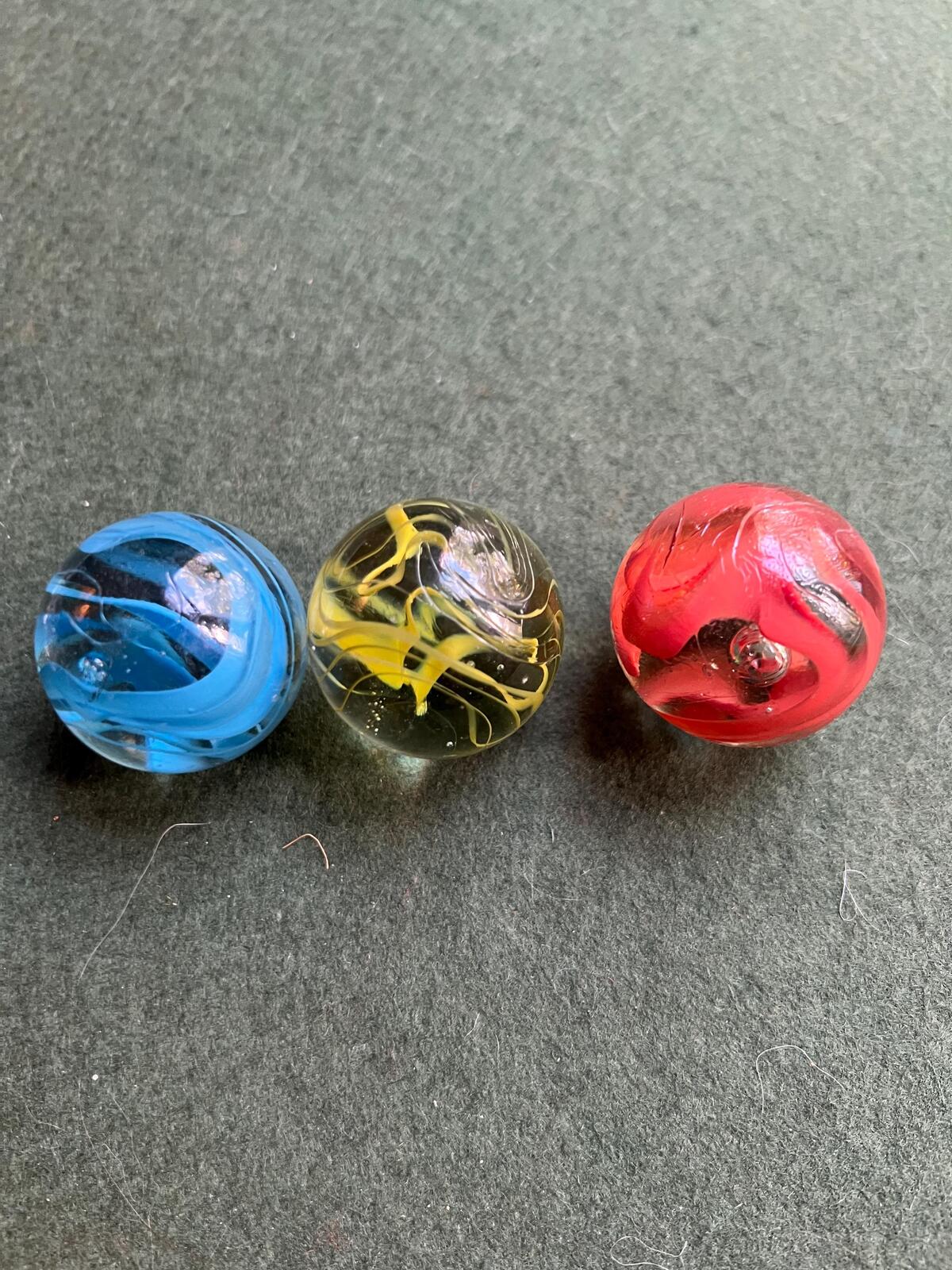 Set 3 vintage dobber marbles. Red Yellow blue spaghetti swirl.