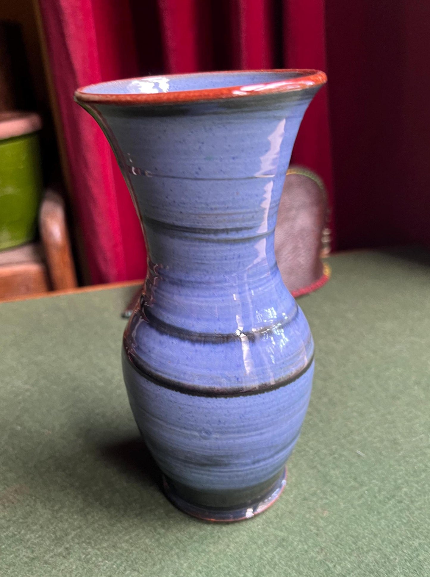 Beautiful vintage studio pottery vase. Blue glaze with black swirl and red rim. Stamped WOLD